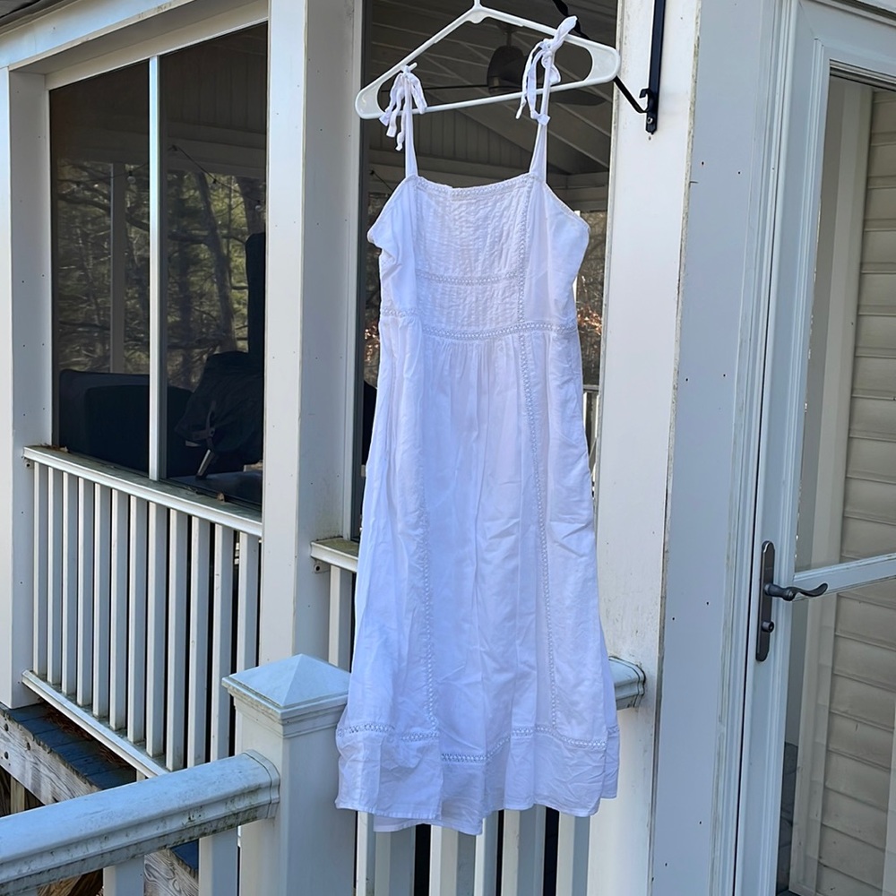 White sundress with tie shoulder straps and embroidered detailing